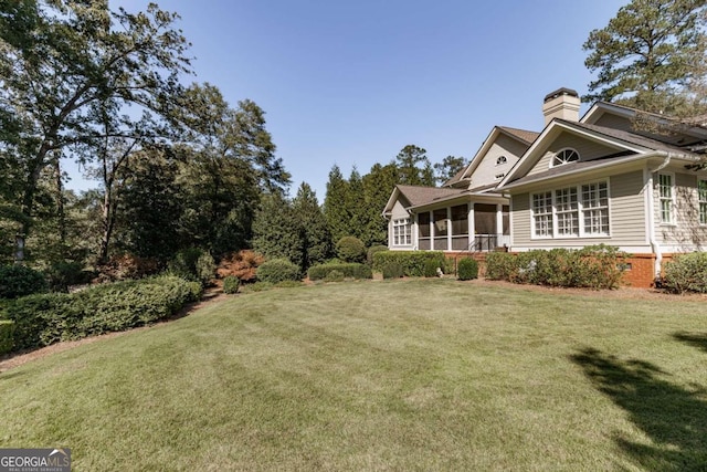 view of yard featuring a sunroom