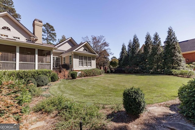 view of yard with a sunroom