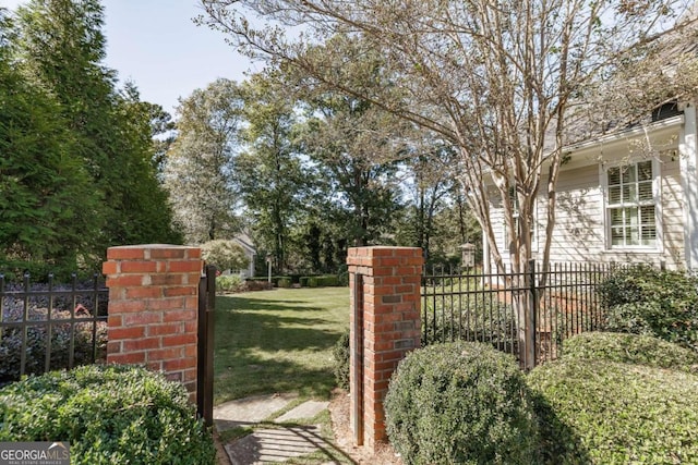 view of gate with a yard