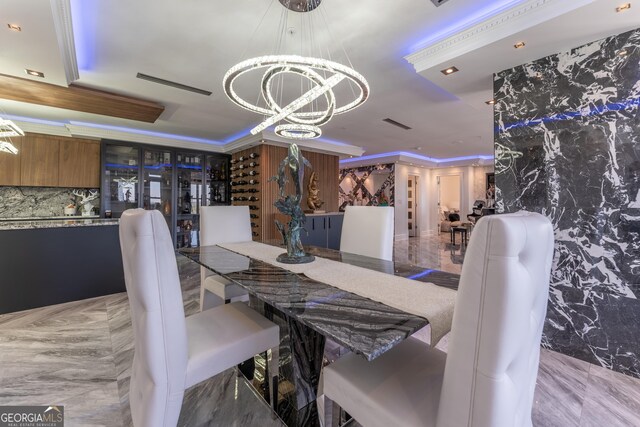 dining room featuring crown molding, visible vents, and a chandelier
