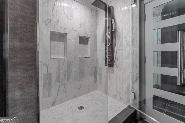 bathroom with a tile shower