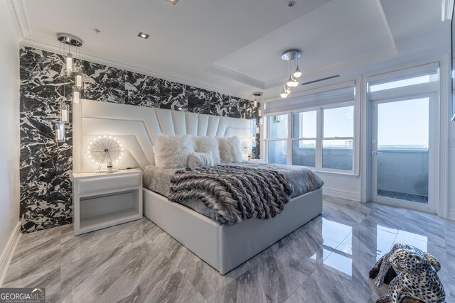 bedroom with a raised ceiling, marble finish floor, crown molding, and access to outside