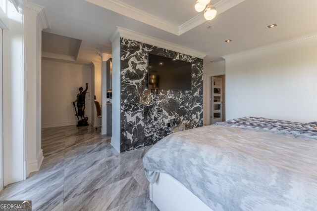 bedroom featuring marble finish floor, ornamental molding, wallpapered walls, baseboards, and an accent wall