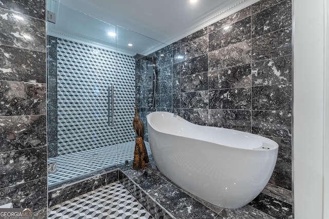 full bath with tile walls, tiled shower, crown molding, and a freestanding bath
