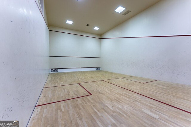 view of home's community featuring visible vents and a sport court