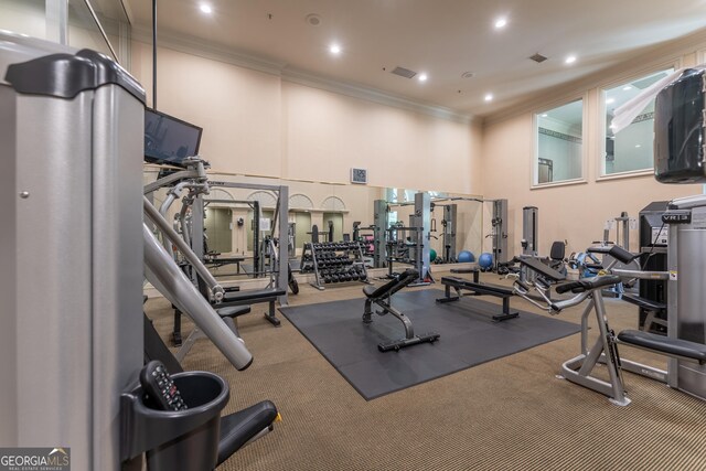gym with visible vents, ornamental molding, carpet flooring, recessed lighting, and a high ceiling