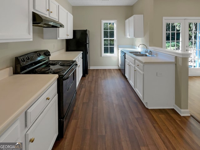 kitchen featuring dark wood-type flooring, plenty of natural light, black appliances, and sink