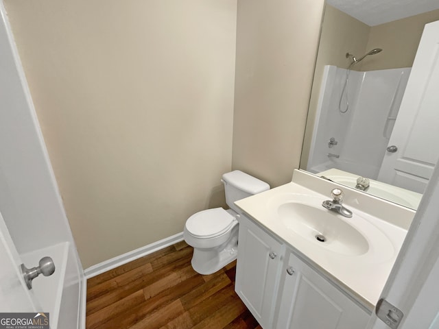 full bathroom featuring tub / shower combination, vanity, toilet, and wood-type flooring