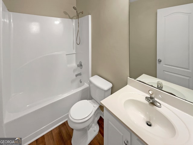 full bathroom with shower / bathing tub combination, wood-type flooring, vanity, and toilet