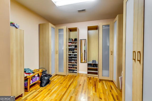 hallway with light hardwood / wood-style floors