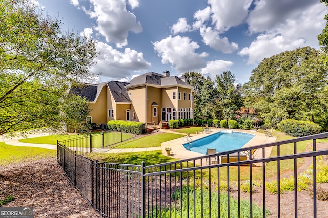 view of swimming pool with a yard and a patio area