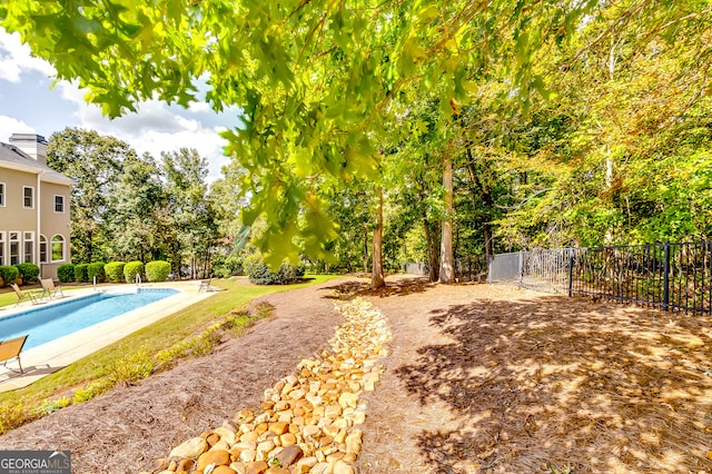 view of yard featuring a fenced in pool