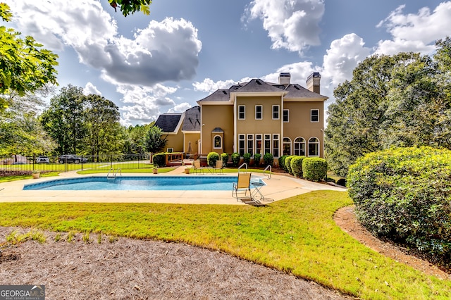 view of swimming pool with a yard and a patio area