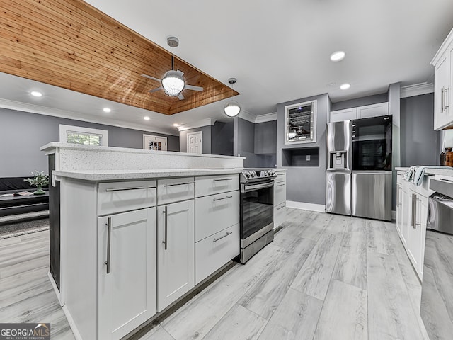 kitchen featuring a kitchen island, crown molding, white cabinetry, light hardwood / wood-style flooring, and decorative light fixtures