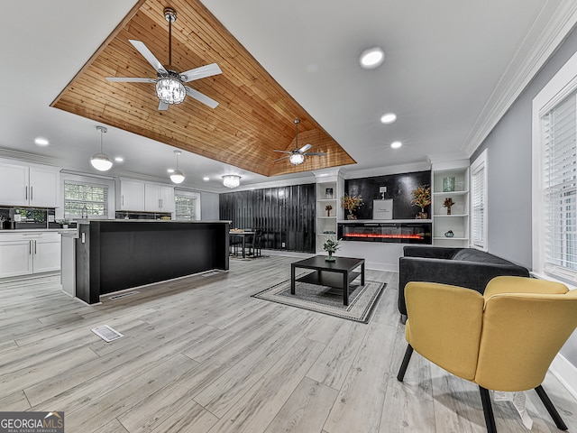 living room featuring light wood-type flooring, ceiling fan, wooden ceiling, crown molding, and vaulted ceiling