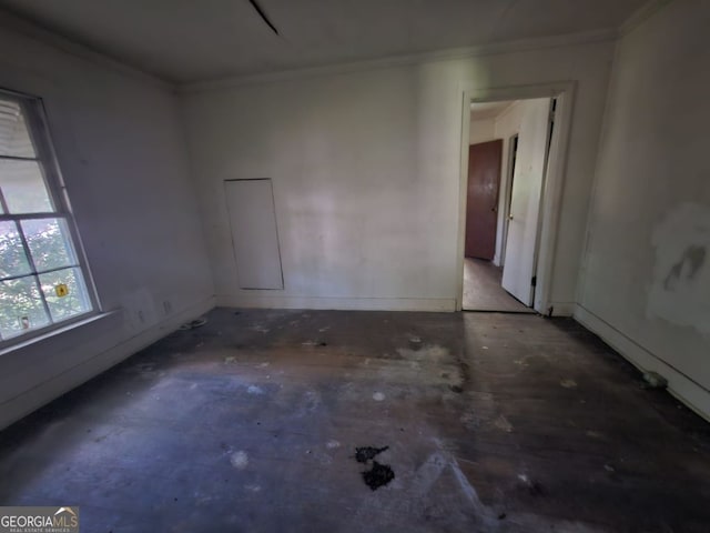 unfurnished room with crown molding