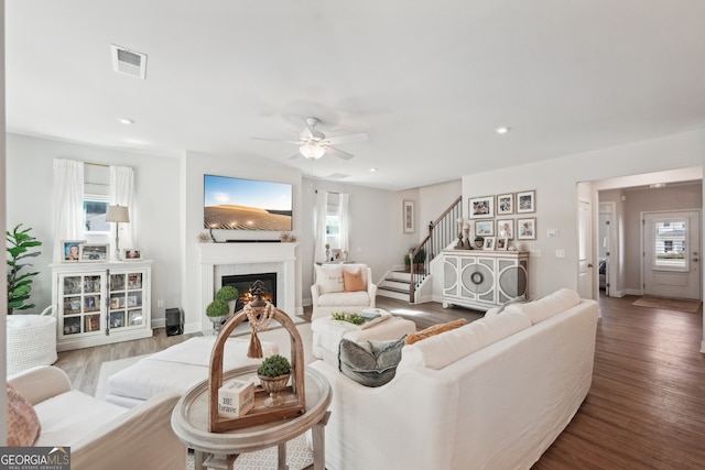 living room with wood-type flooring and ceiling fan