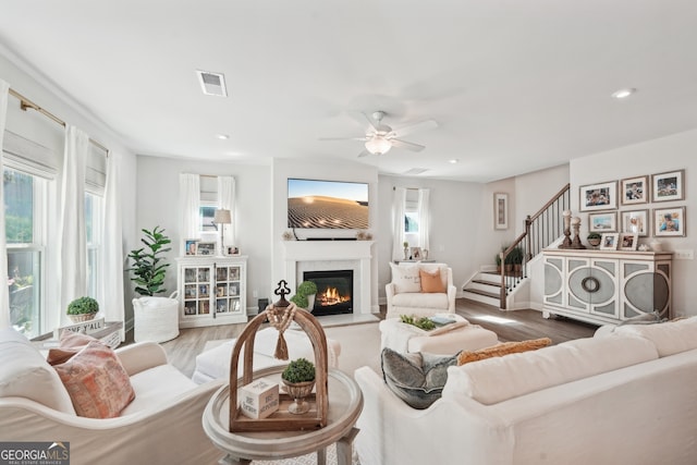 living room featuring hardwood / wood-style flooring and ceiling fan