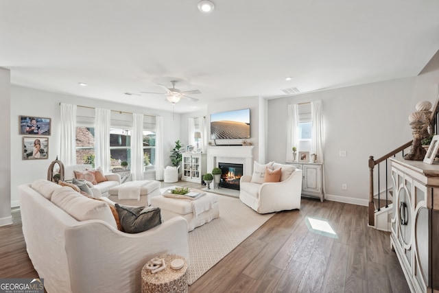 living room featuring dark hardwood / wood-style floors and ceiling fan