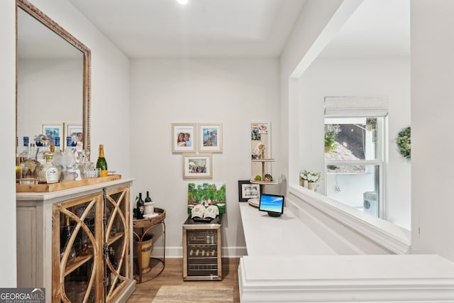 wine area featuring hardwood / wood-style floors and indoor bar