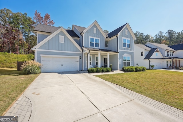 view of front of property featuring a porch, a front lawn, and a garage