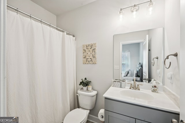 bathroom featuring toilet and vanity