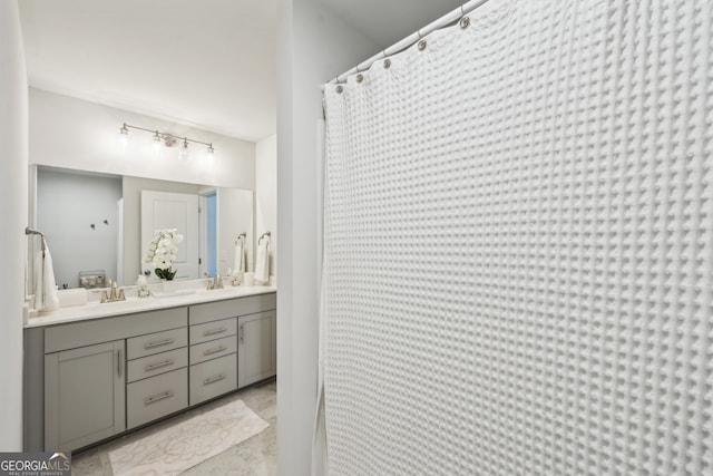 bathroom featuring vanity and curtained shower