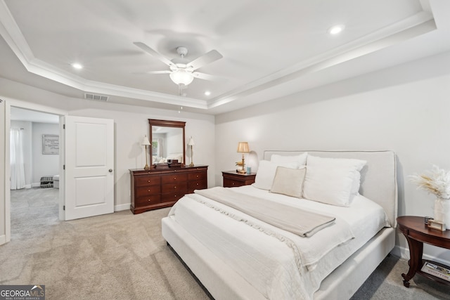 bedroom featuring light carpet, ornamental molding, ceiling fan, and a raised ceiling