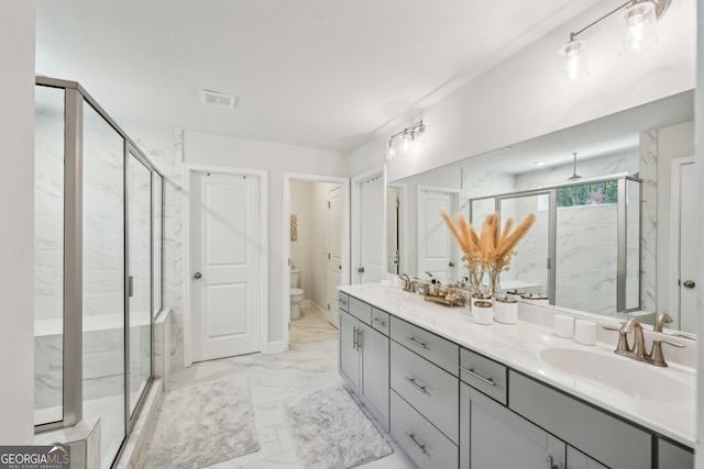 bathroom with toilet, an enclosed shower, and vanity