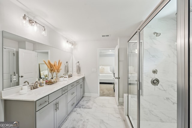 bathroom featuring a shower with door and vanity