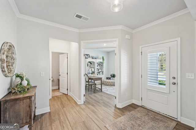 entrance foyer featuring crown molding and light wood-type flooring