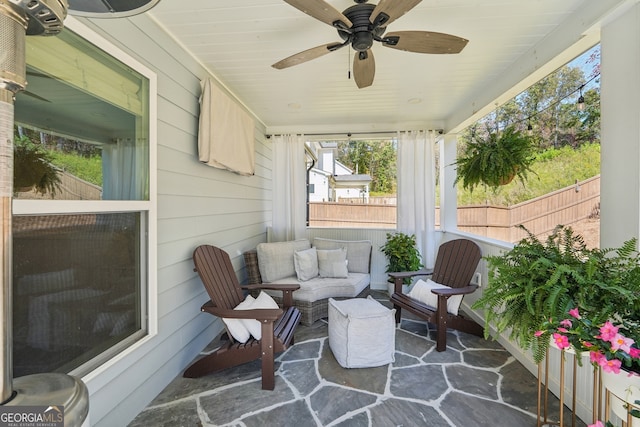 sunroom featuring ceiling fan