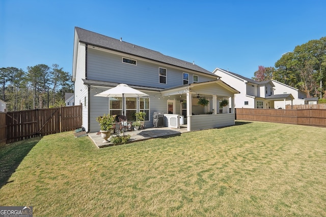 rear view of property with a patio area and a lawn