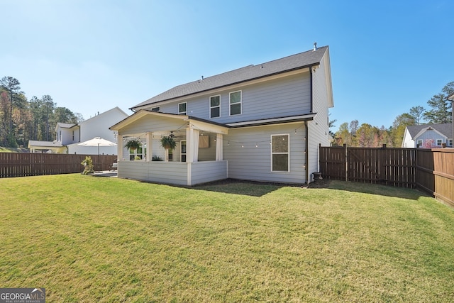 rear view of property with a lawn