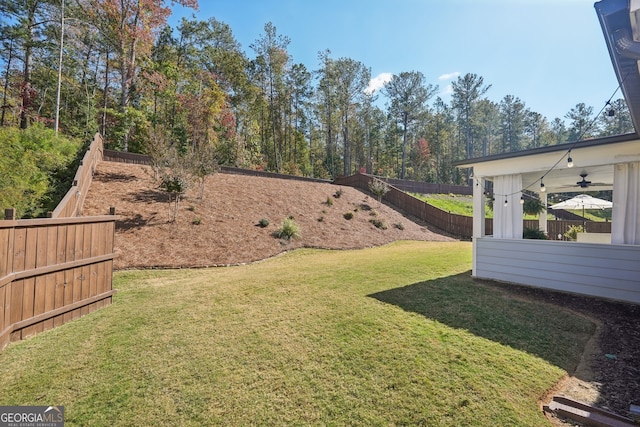 view of yard featuring ceiling fan