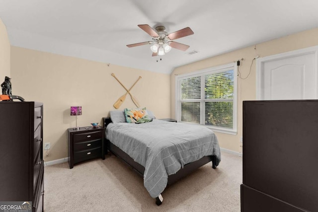 bedroom featuring light carpet and ceiling fan