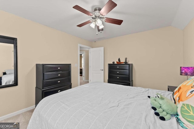 carpeted bedroom with ceiling fan and vaulted ceiling