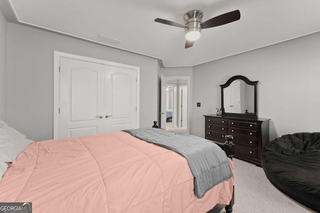 carpeted bedroom featuring a closet and ceiling fan