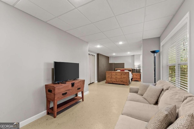 living room featuring a paneled ceiling