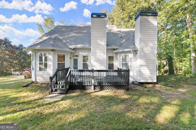 back of house with a yard and a deck