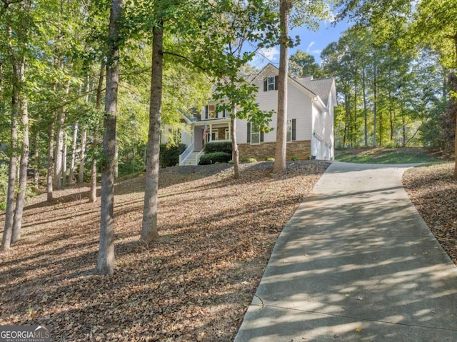 view of side of property with covered porch