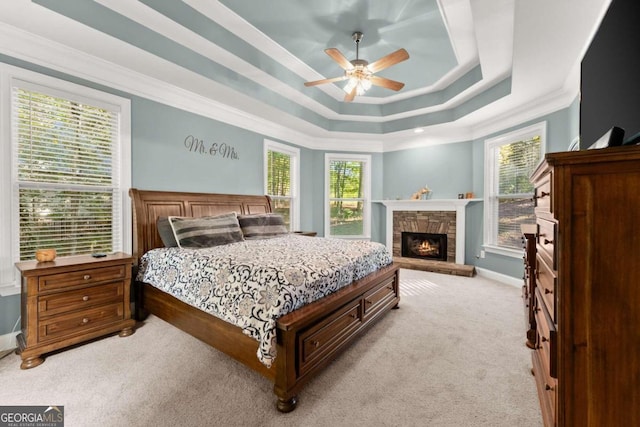 bedroom with light colored carpet, multiple windows, and ceiling fan