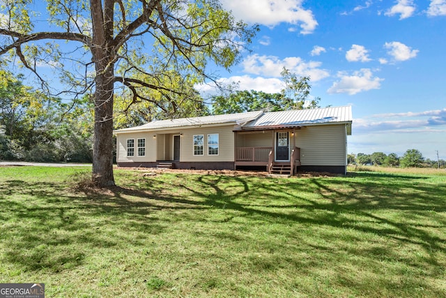 single story home with a front lawn and a deck