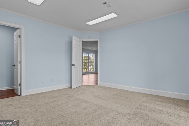 carpeted empty room featuring ornamental molding