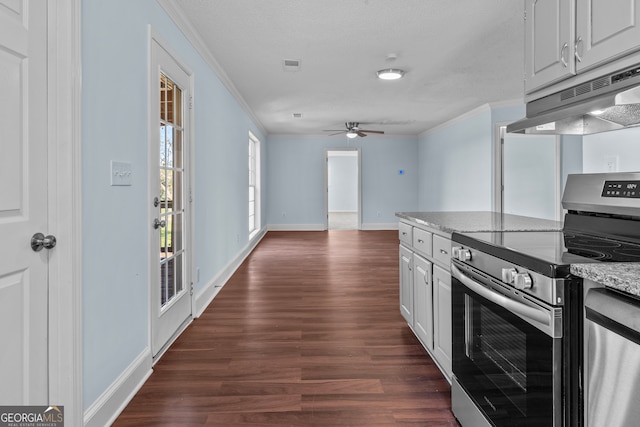 kitchen with ceiling fan, dark hardwood / wood-style flooring, crown molding, white cabinetry, and appliances with stainless steel finishes