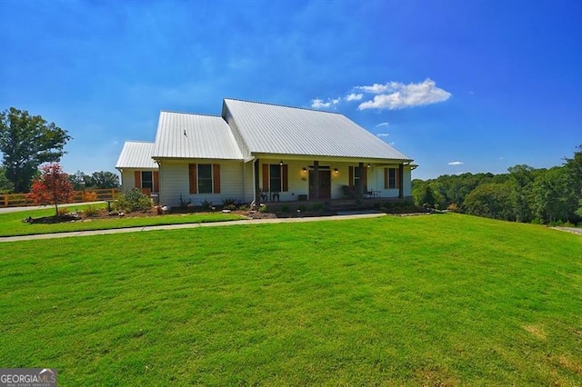 view of front of property with covered porch and a front yard