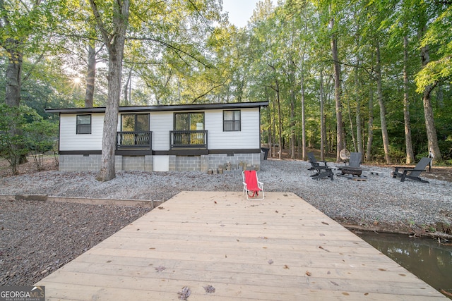 rear view of property featuring a deck