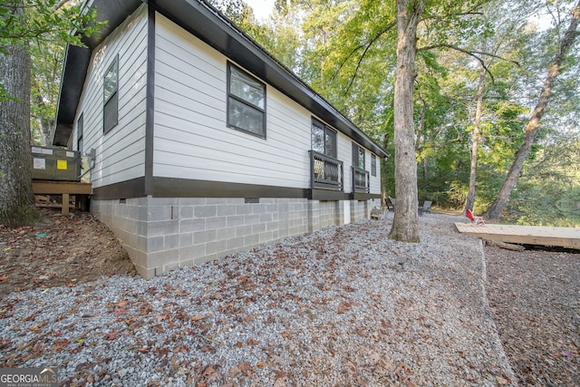 view of side of property featuring a wooden deck