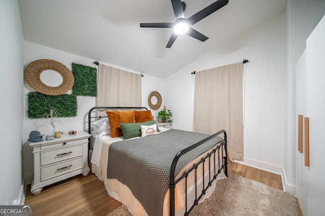 bedroom featuring ceiling fan, lofted ceiling, and light hardwood / wood-style floors