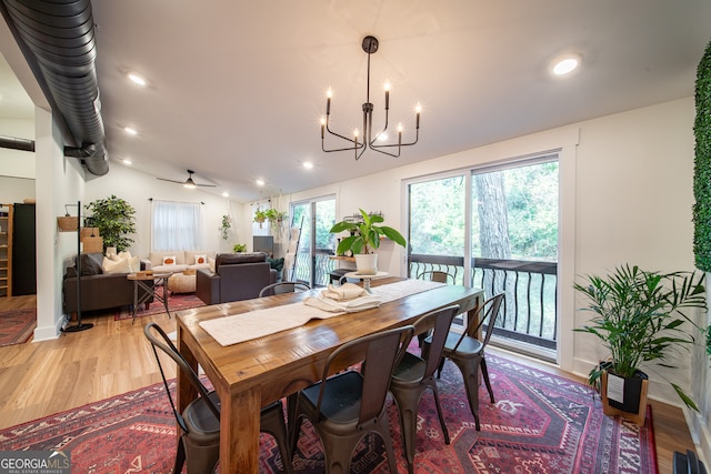 dining room with wood-type flooring and ceiling fan with notable chandelier